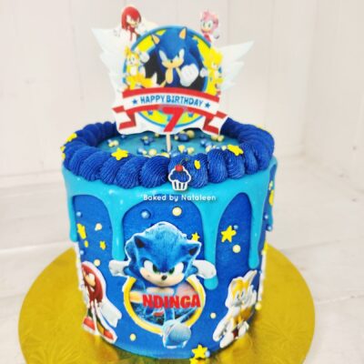 Sonic the Hedgehog–themed birthday cake with blue icing, star decorations, and a 'Happy Birthday 7' topper.
