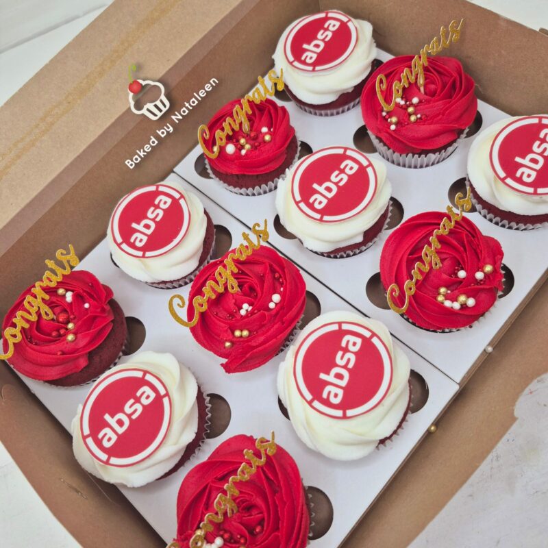 Box of twelve cupcakes in a cardboard bakery box, red and white frosting with ABSA logo toppers and gold 'Congrats' toppers.