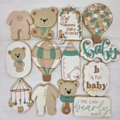 Assorted baby shower cookies in pastel bears, balloons, and cake designs used for a celebration setting