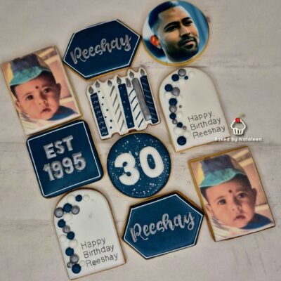 Assorted blue and white birthday cookies and decorations celebrating Reeshay's 30th birthday, including 'Happy Birthday Reeshay' and a cake with 30.
