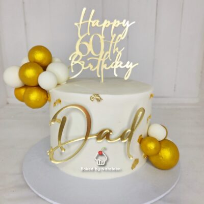 White fondant birthday cake with a gold script 'Dad' and a 'Happy 90th Birthday' topper, plus gold and white edible decorations on the side and top edge of the cake.
