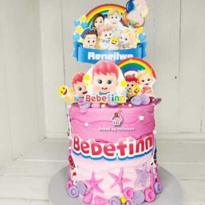 Two-tier pink Bebefinn birthday cake with colorful toppers, rainbow arches, and the Bebefinn logo (baked by Natalee).