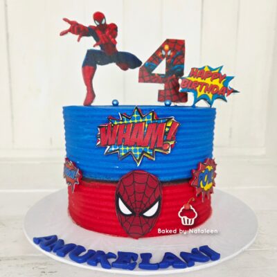 Spider-Man themed birthday cake with red and blue layers, a '4' topper, Spidey figure on top, and comic-style decor including 'WHAM!' and 'Happy Birthday' bubbles.