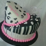 Funky 2-tier musical theme birthday cake in black and pink trim