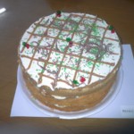 Angel triple-decker cake crammed with caramel cream frosting and criss-cross caramel decoration