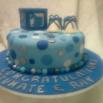 Baby shower cake in blue with polka dots, baby block topper in blue with white and blue booties